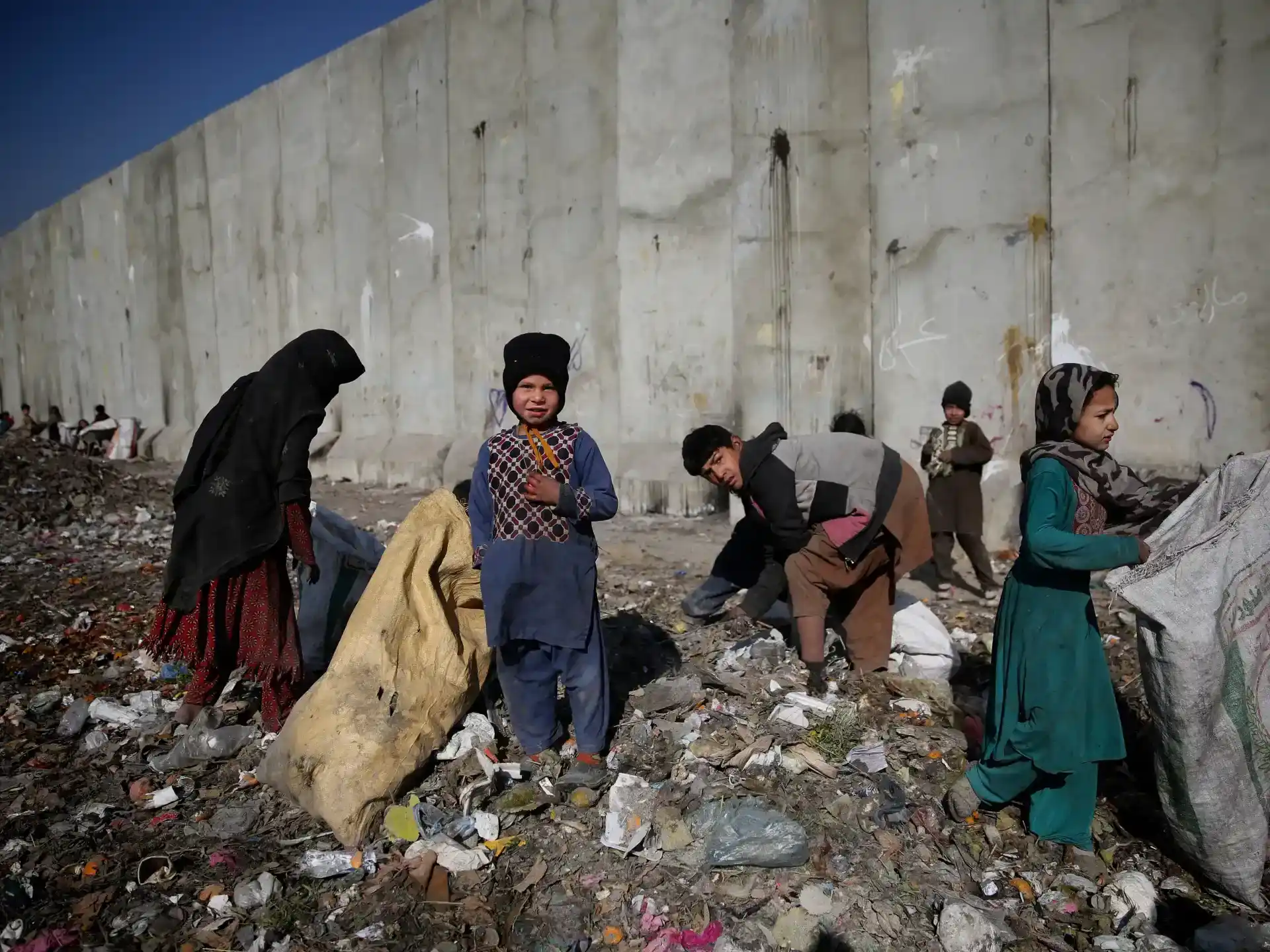 A group of smiling children looking up at the camera.