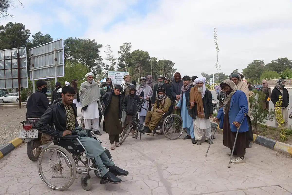 A group of smiling children looking up at the camera.